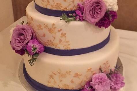 3-tier wedding cake with purple and gold details