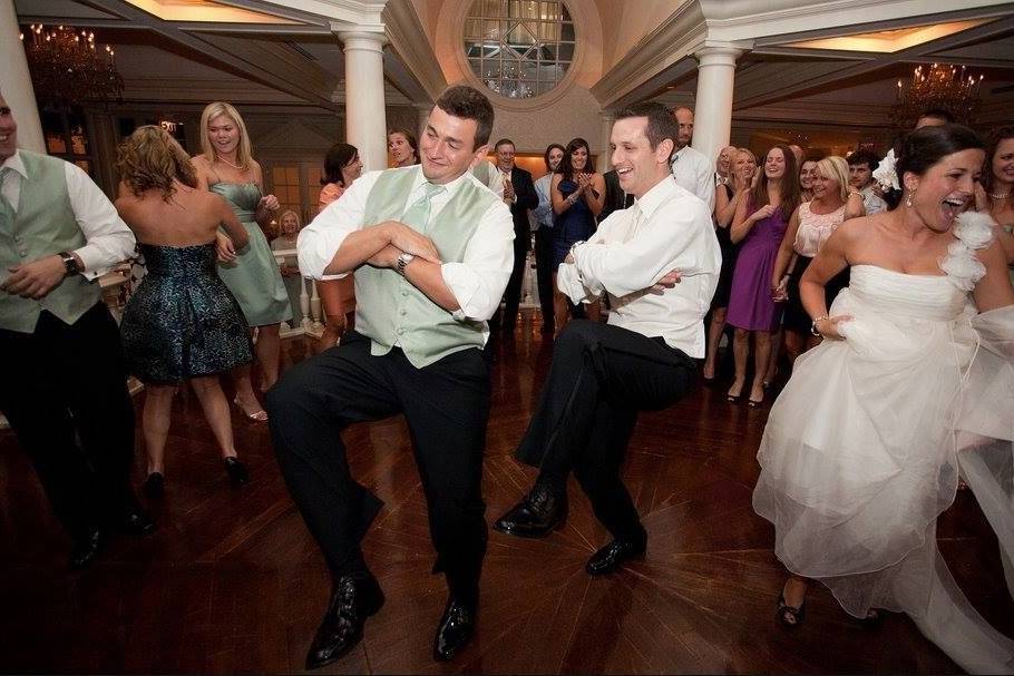 Newlyweds and guests dancing