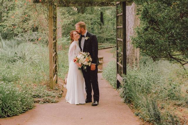 Bride and groom under a wooden