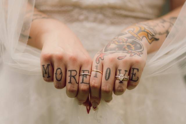 Bride's tattooed hands resting
