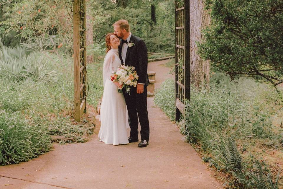 Bride and groom under a wooden
