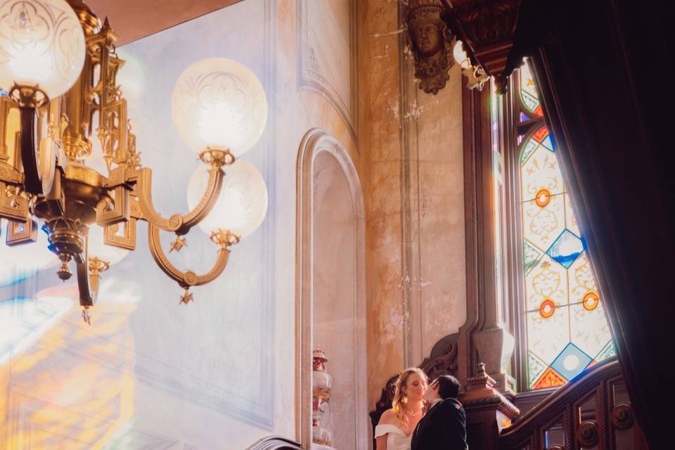 Couple on a staircase lit b