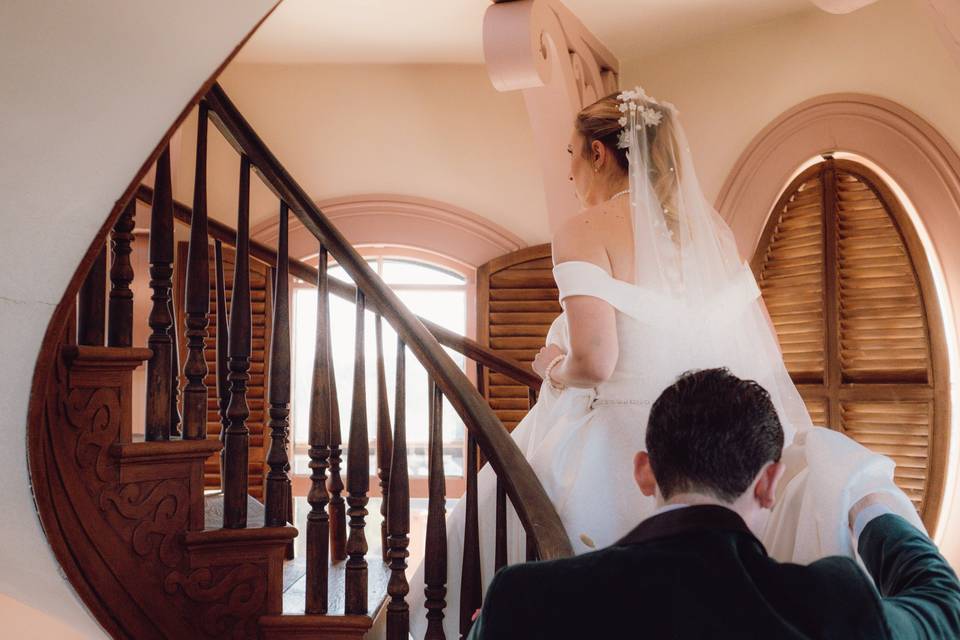 Bride pausing on a wooden stai