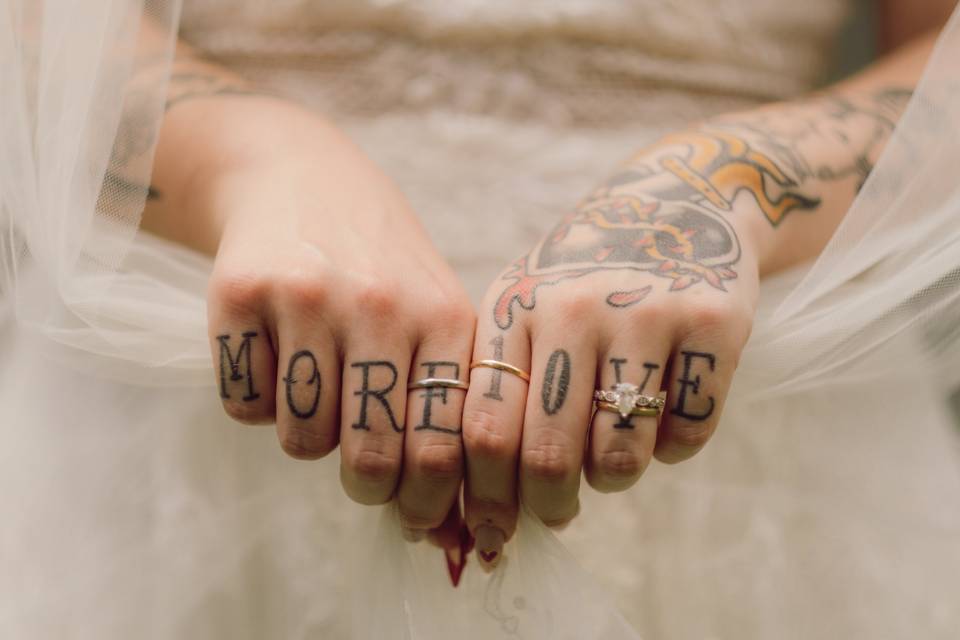 Bride's tattooed hands resting