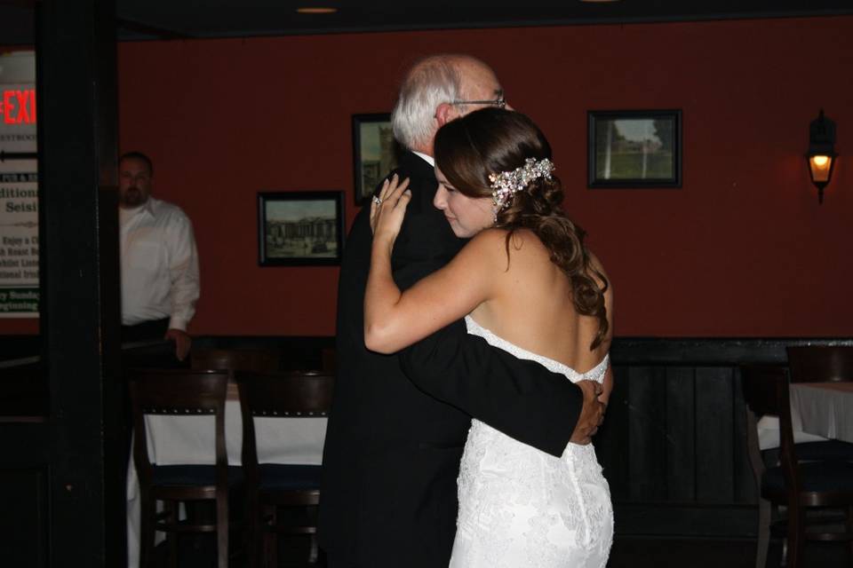 The bride and her father dancing