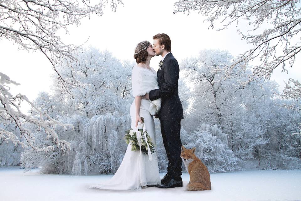 Bride and groom in the snowy woods
