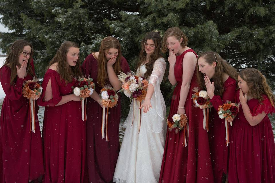Bridesmaids looking at ring.