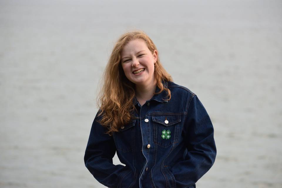 Smiling girl by lake