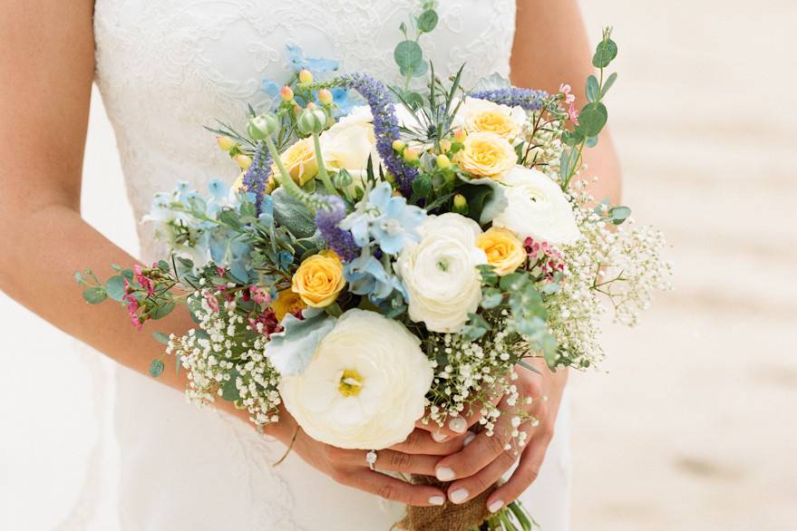 Bride on the beach with her bouquet