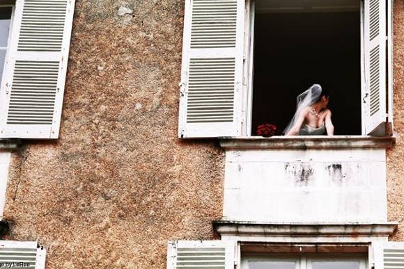 Kim looks out her dressing room window at Chateau St. Julien l'ars, Potiers, Frnace.