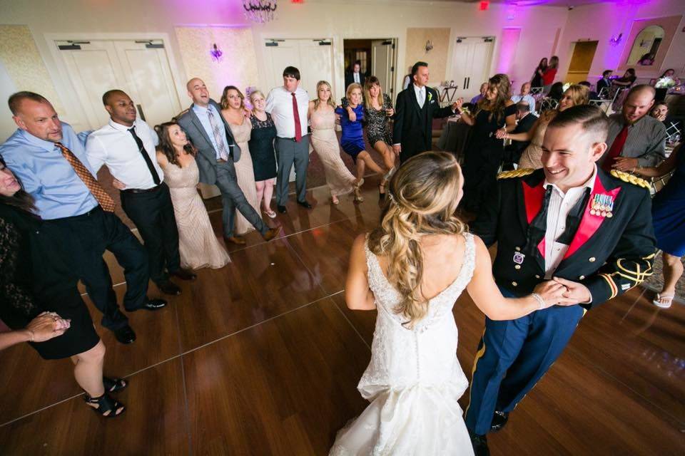 Newlyweds dancing with guests