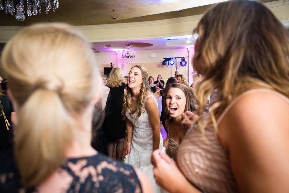 Newlyweds dancing with guests