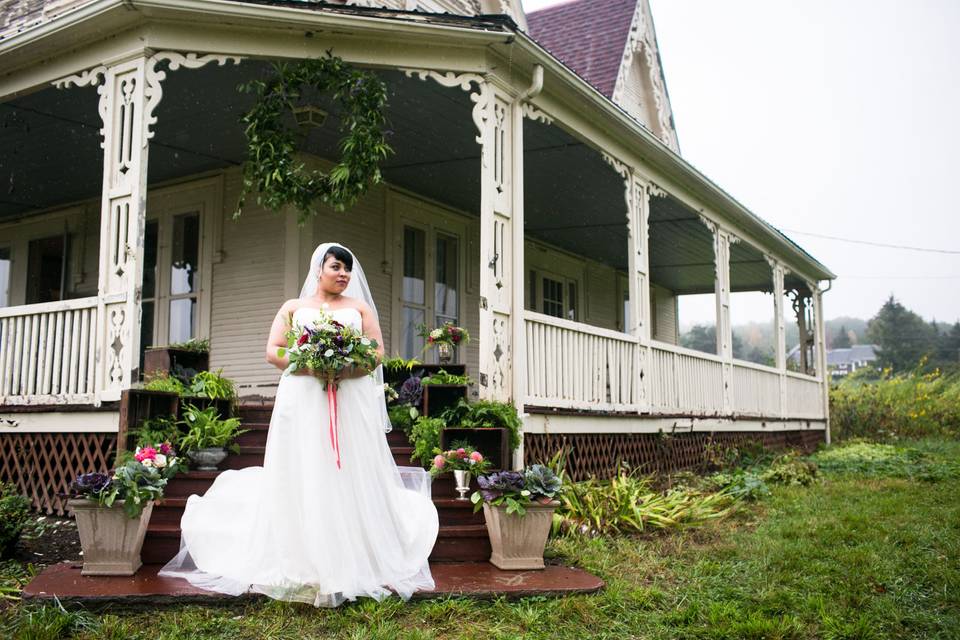 Bride in front of the farm