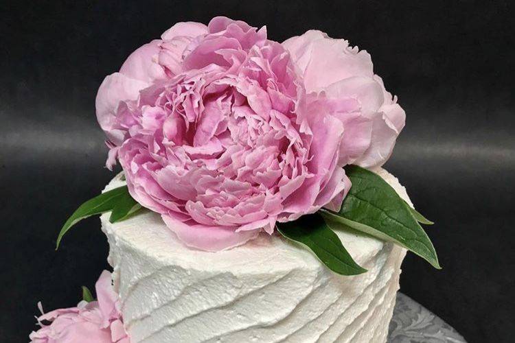 Fresh peonies on a cutting cake