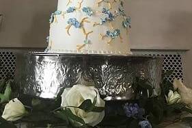 Three tiered wedding cake with hand crafted hydrangea flowers