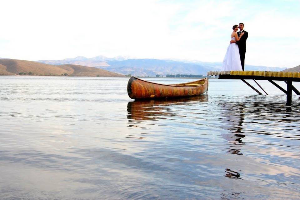 Newlyweds kissing on the dock