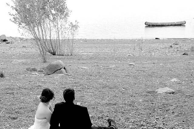 Bride and groom sitting and looking at the waters