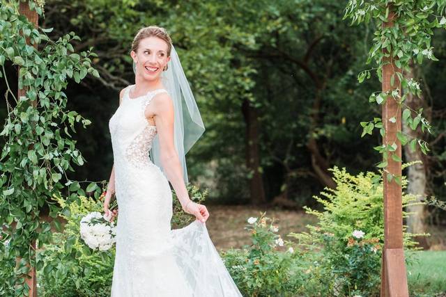 Bride smiling under arbor