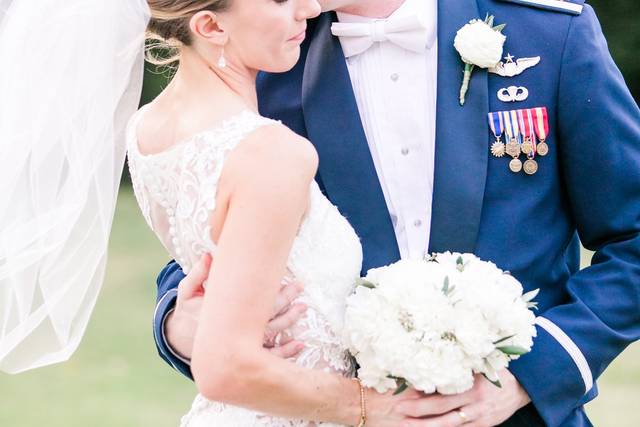 Bride and groom embrace outside