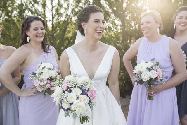 Bride laughing with bridesmaids
