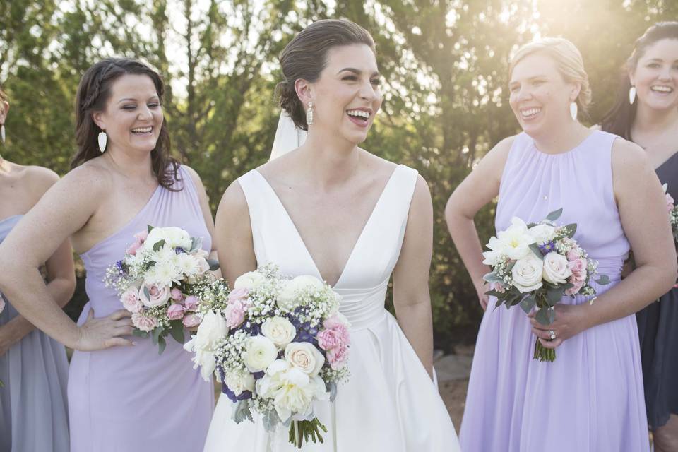 Bride laughing with bridesmaids