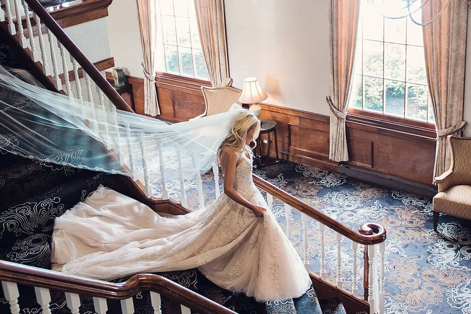 Walking down the staircase in white gown