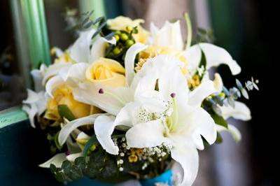 Spring bridal bouquet with white lilies, yellow roses and babies breath.