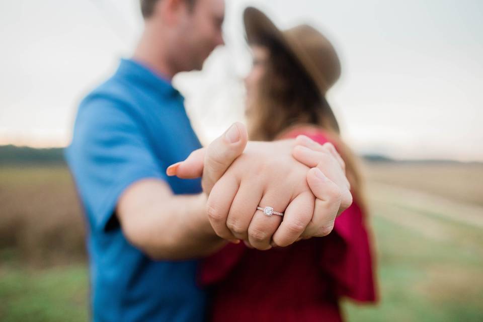 Couple showing engagement ring