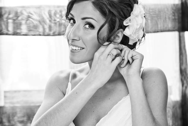 Bride putting on her earrings