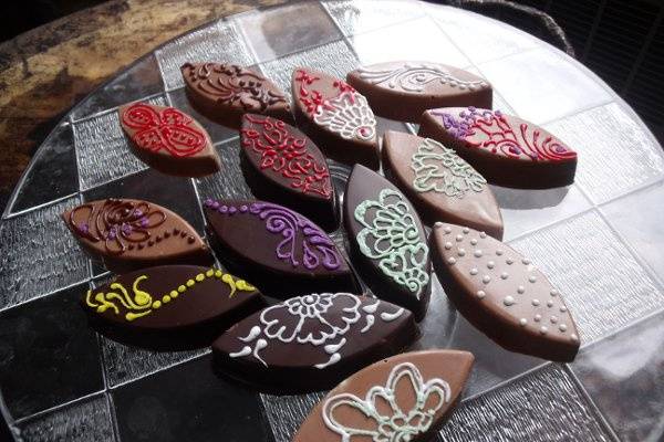 Leaf shaped chocolates, decorated by hand with colored icing