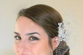 Glass pearls and faceted crystals wired onto a small, silver hair comb.