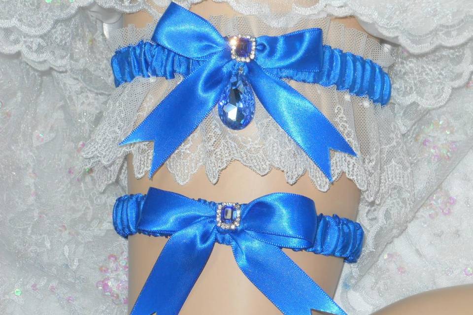 Satin and lace traditional garter with Sapphire crystal gem drop. Available in Emerald, Ruby, Pale Pink, Tiffany Blue and Citrine yellow.