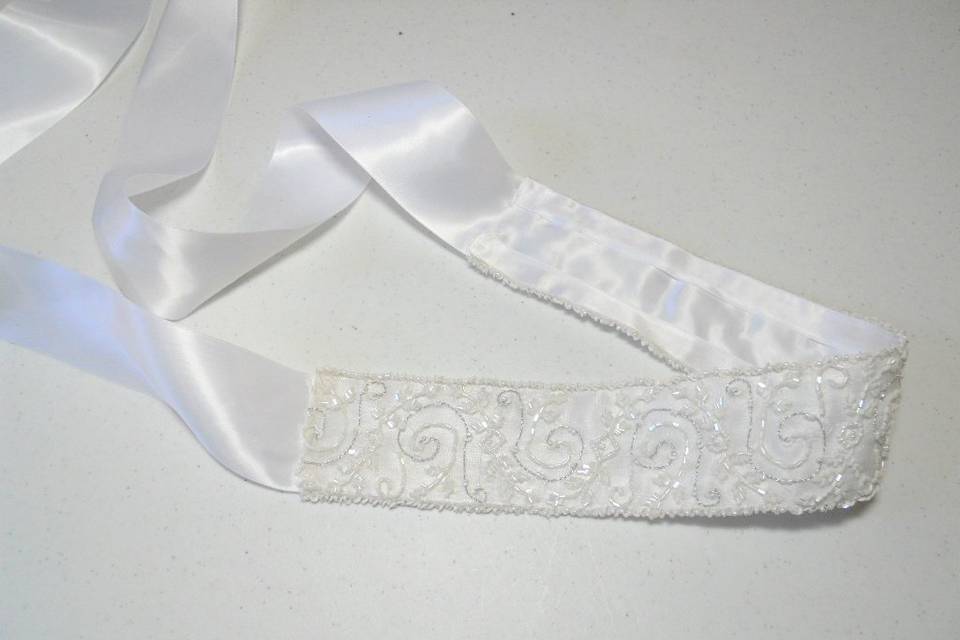 Hand beaded sash in white silk over satin.