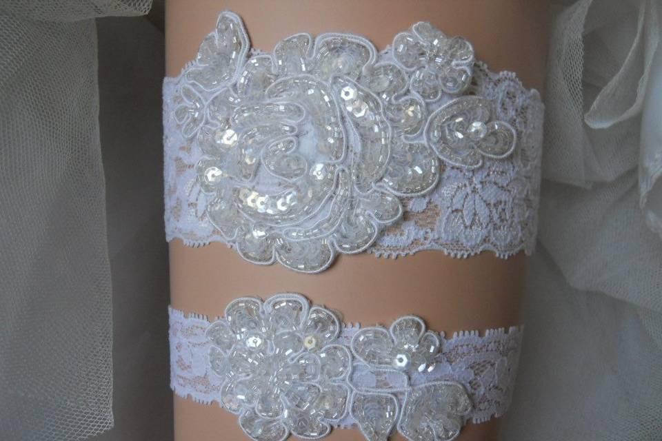 Stretch lace garter set with beaded floral appliques.
