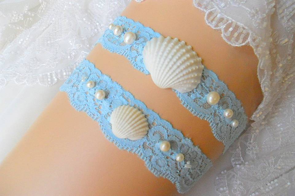Getting married by the sea? Wear a garter set of real freshwater pearls and white sea shells on soft blue stretch lace for the look any mermaid would envy.