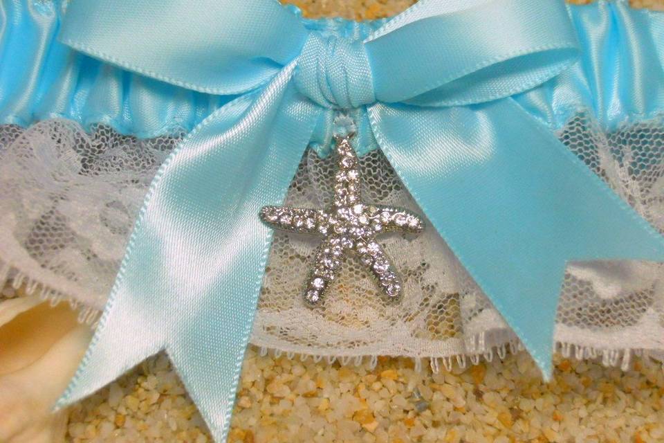 Crystal starfish garter in blue satin and white lace.