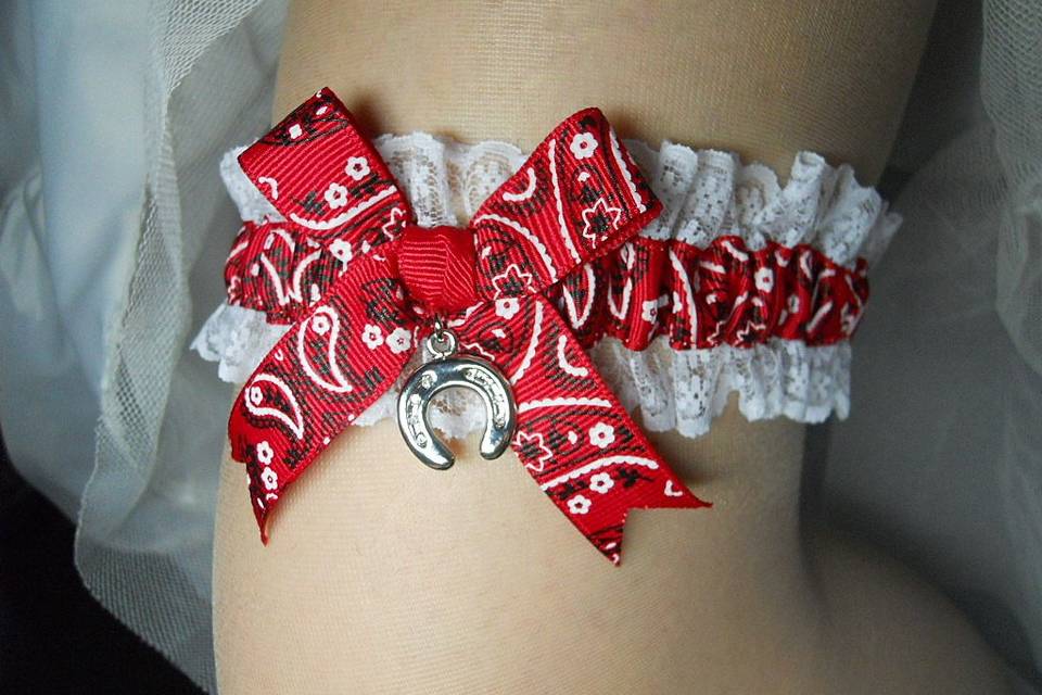 Country Western style garters in traditional bandana print gussied up with lace and silver charms of a hat, boots and a horseshoe for good luck!