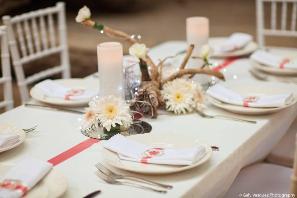 Bespoke napkin rings and a simple tablescape of driftwood, flowers and light