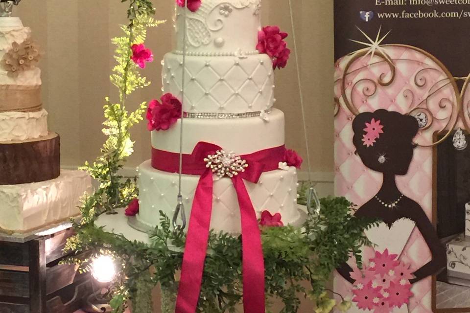 Pink ribbon on wedding cake