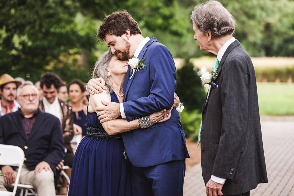 Family hugs down the aisle.