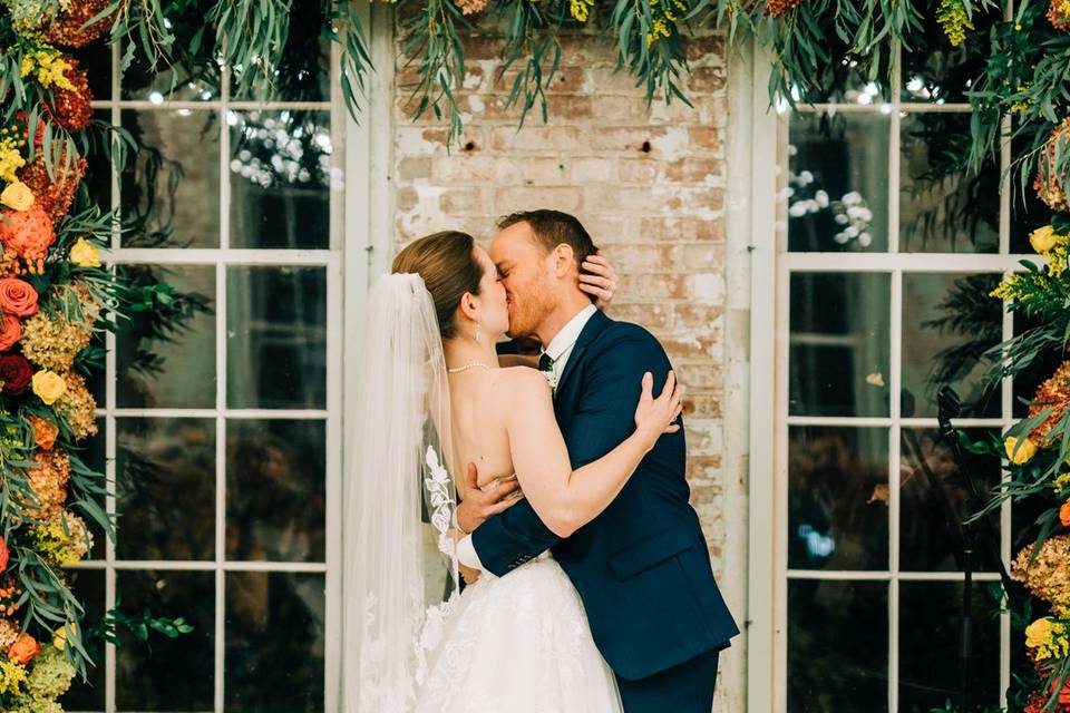 Kiss under a floral arch