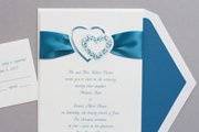Satin ribbon is included with this adorable invitation. A pair of peacock-colored hearts playfully grace the top.