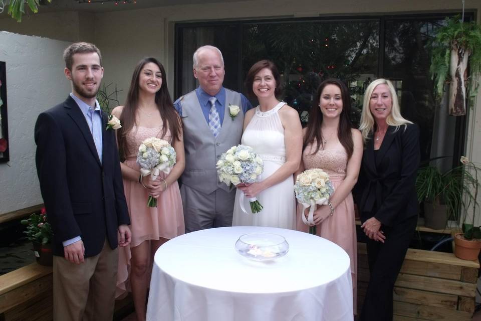 Newlyweds and their guests with the officiant