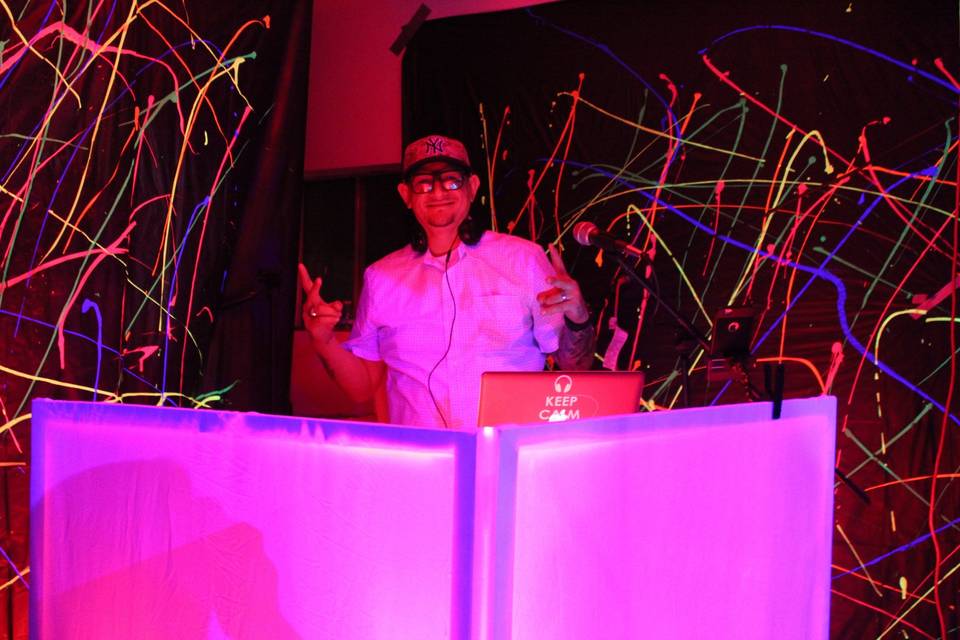 DJ Strech behind the DJ booth, Glow party February 2018