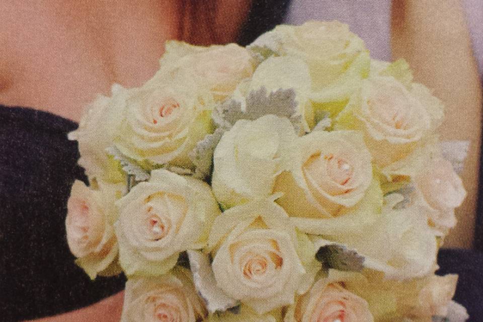 Bride's bouquet of roses and dusty miller with pearl accents for Central Park wedding.