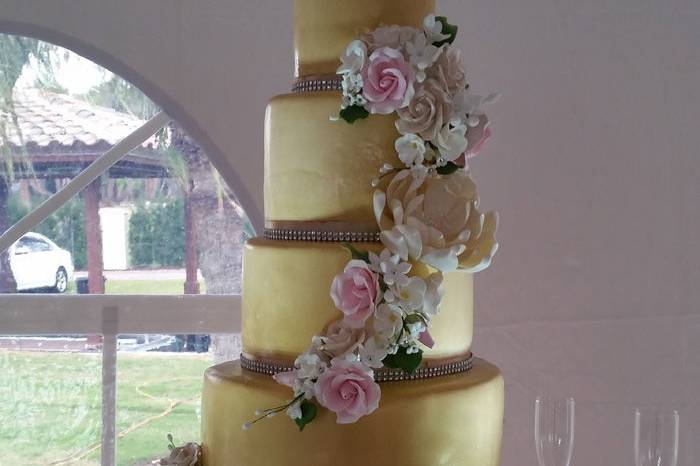 Gold wedding cake with a white base tier
