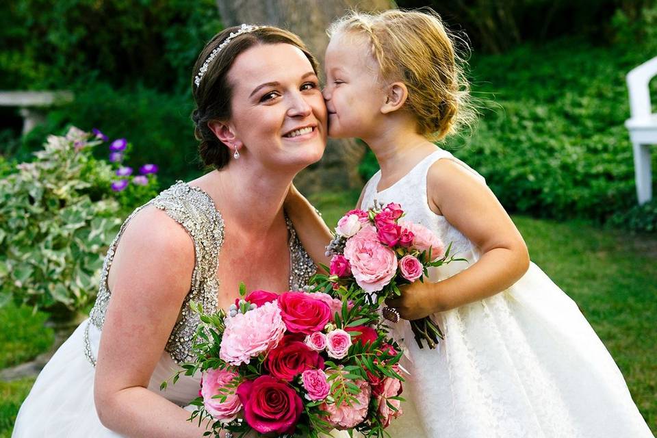 A bride with her flower girl - matching bouquets.