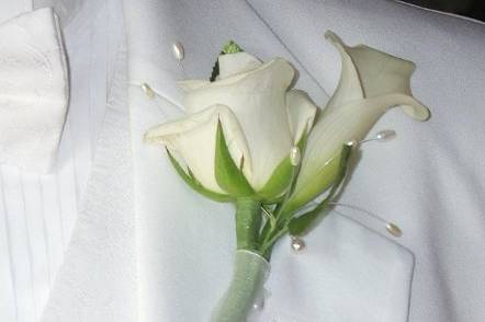 Pick unique flowers like mini callas with small roses wrapped with chiffon to show off your groom.  Remember he will be in all your photos on this special day!