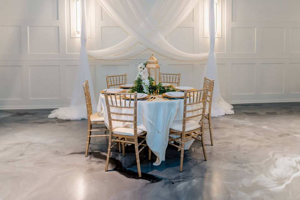 Gold chairs and white drapes