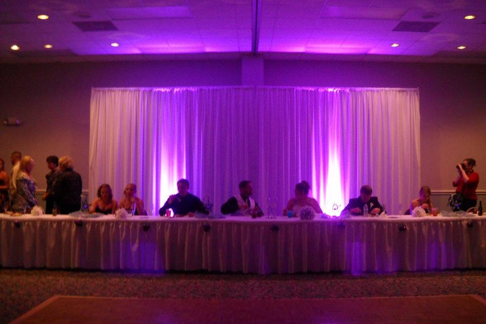 Head table with uplighting at navarre conference center